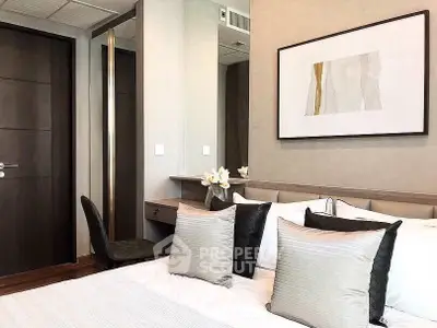 Modern bedroom with elegant decor and stylish furniture, featuring a cozy bed and contemporary artwork.