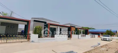 Modern single-story homes with sleek design and spacious driveways in a serene neighborhood.