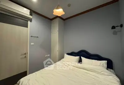 Cozy bedroom with modern lighting and plush bedding