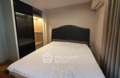 Cozy bedroom with modern wardrobe and air conditioning in a stylish apartment.