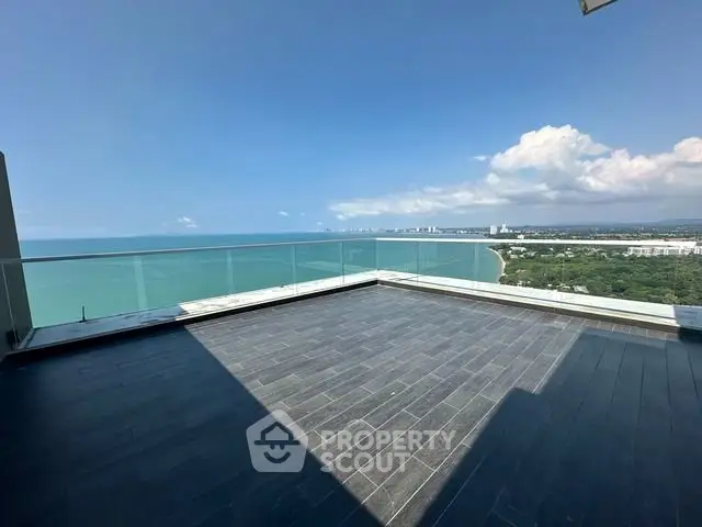 Stunning ocean view from a spacious balcony in a high-rise apartment.
