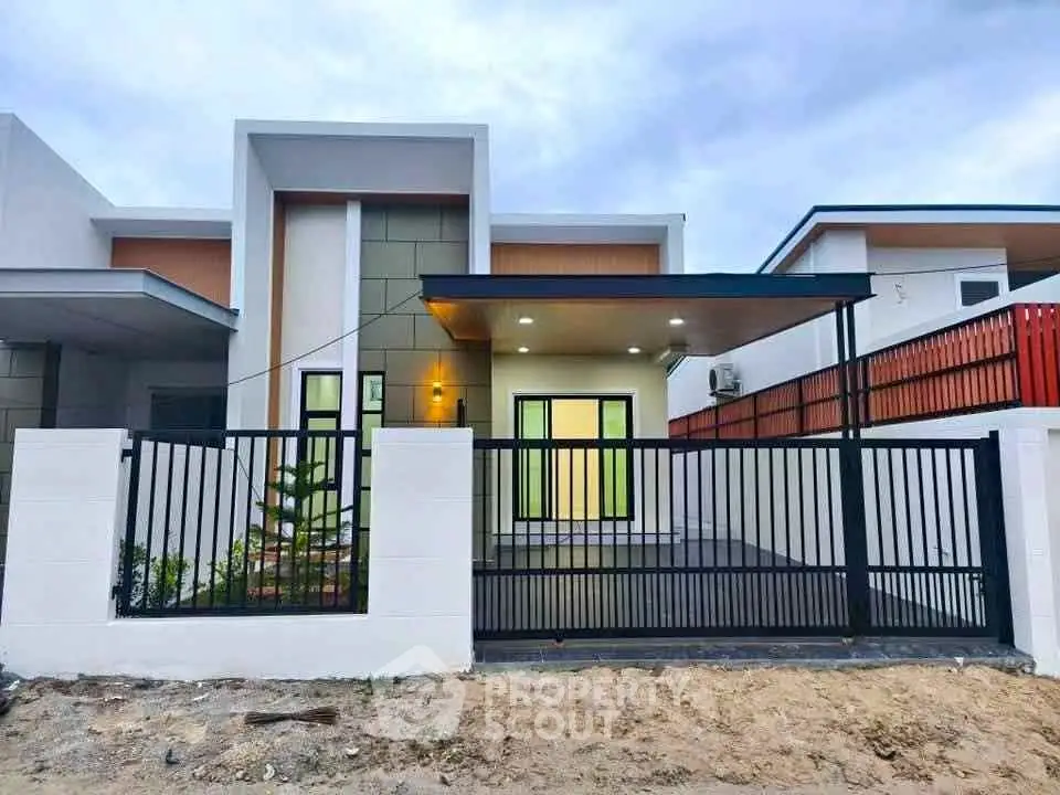 Modern single-story house with sleek design and gated entrance, perfect for contemporary living.