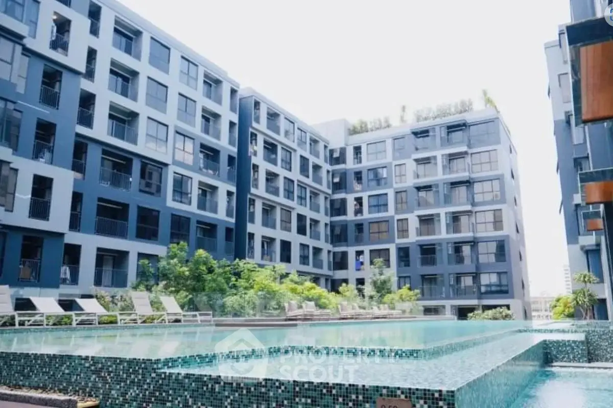 Modern apartment complex with stunning pool and lush greenery