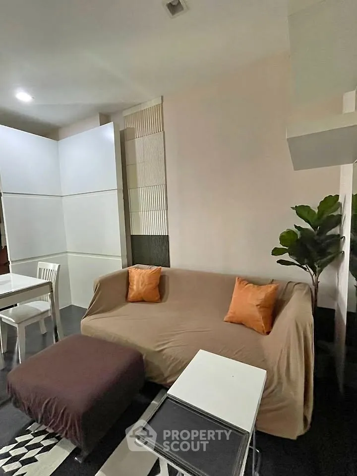 Cozy living room with modern decor and comfortable seating in a stylish apartment.