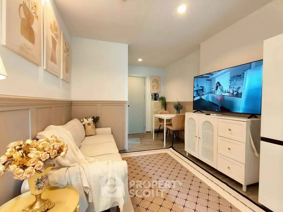 Charming living room with cozy decor and modern TV setup, perfect for relaxation and entertainment.