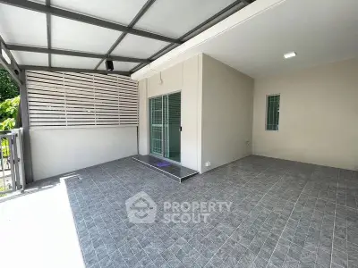 Spacious covered patio with modern design and tiled flooring