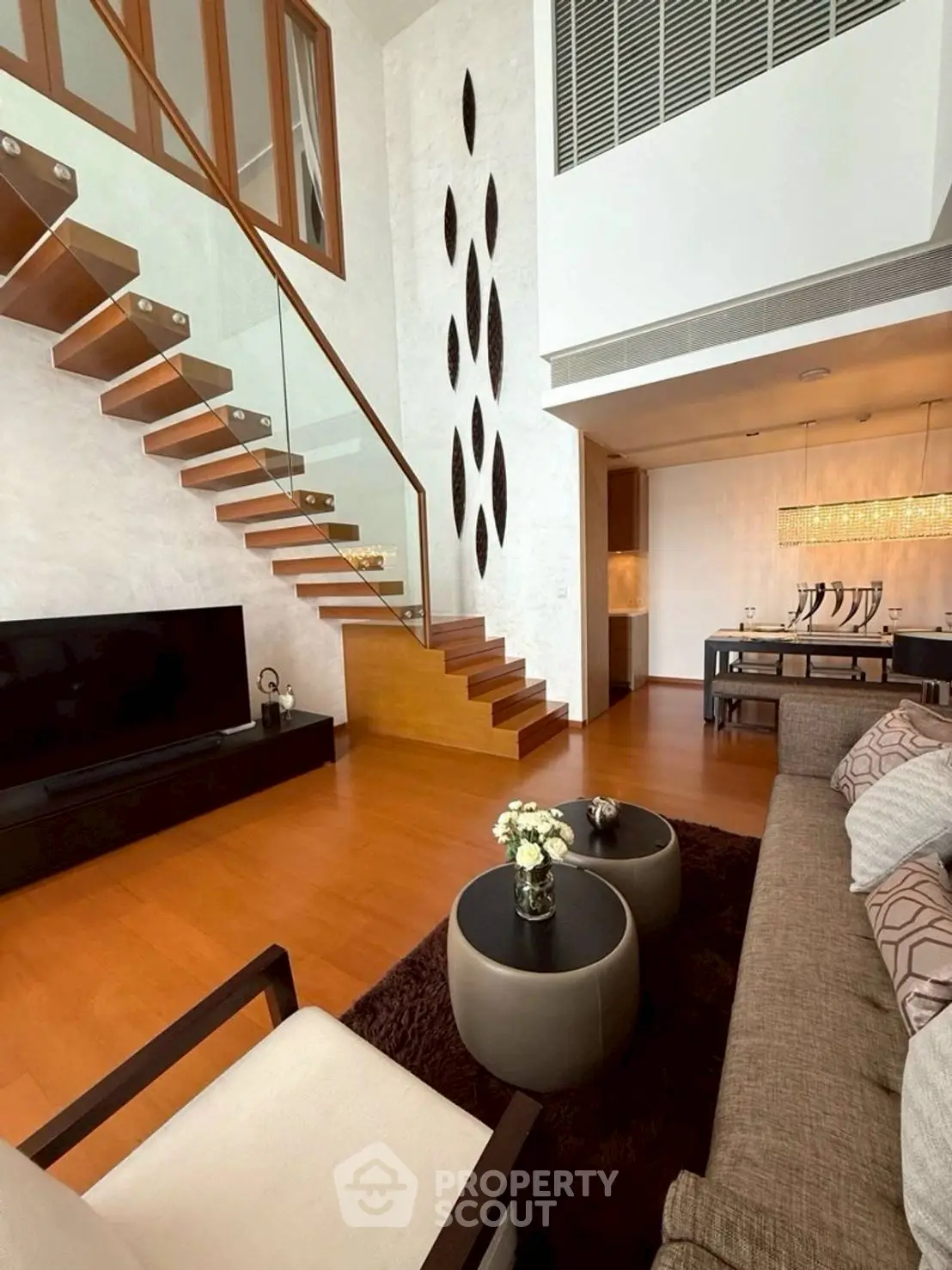 Luxurious modern living room with elegant staircase and stylish decor