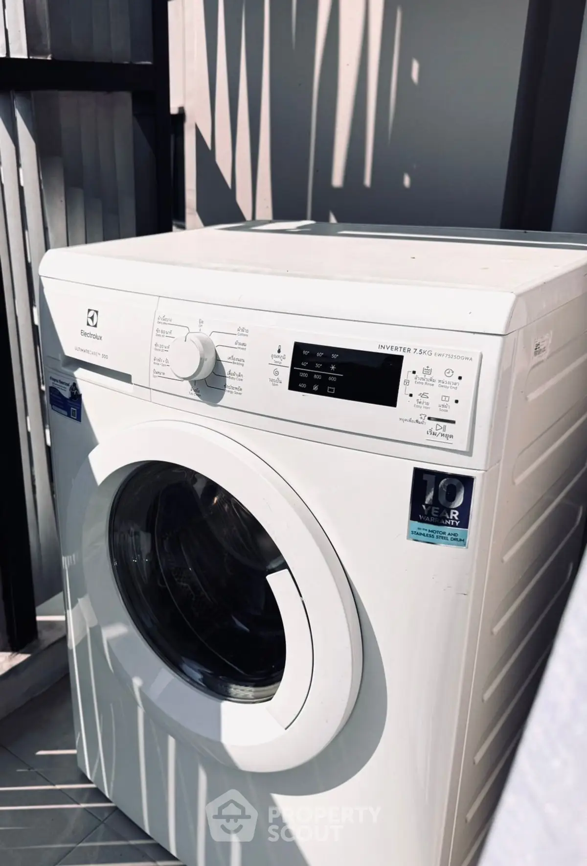 Modern washing machine in a stylish laundry area with natural light.