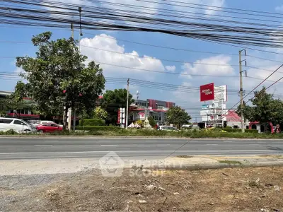 Commercial area with road view and signage under blue sky