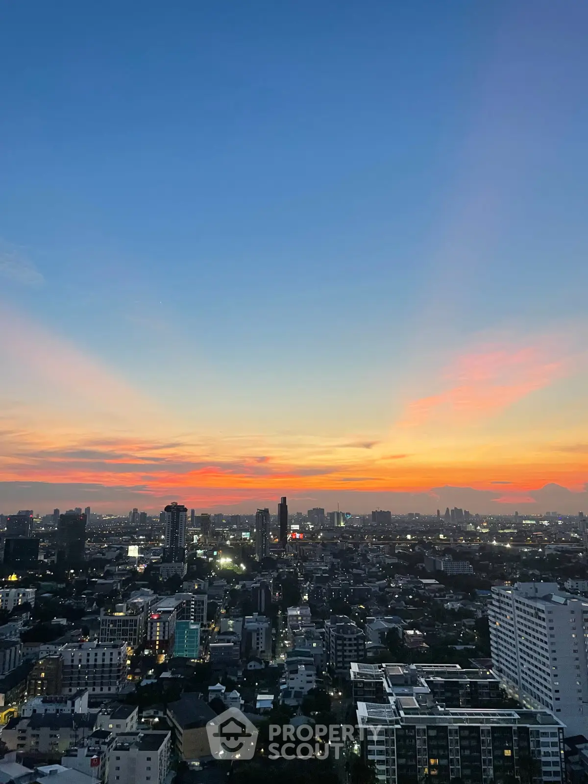 Stunning cityscape view at sunset with vibrant sky colors over urban skyline.