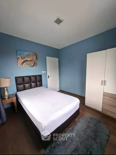 Cozy bedroom with modern decor and plush bedding in a stylish apartment.
