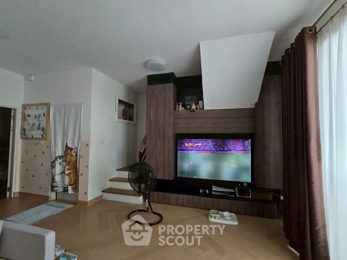 Modern living room with stylish wooden TV unit and cozy decor