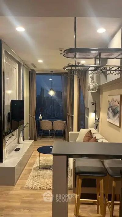 Modern living room with stylish decor and city view, featuring cozy seating and elegant lighting.