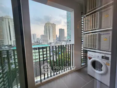 Modern high-rise apartment with balcony and city view, featuring a washing machine for convenience.