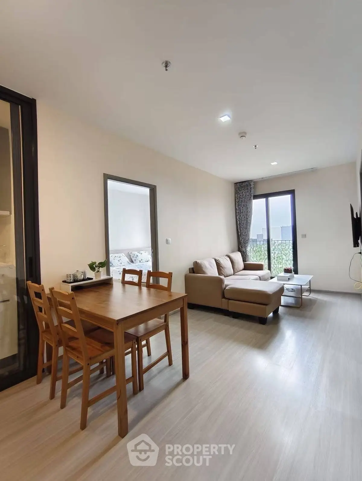 Modern living room with cozy sofa and dining area in open layout apartment