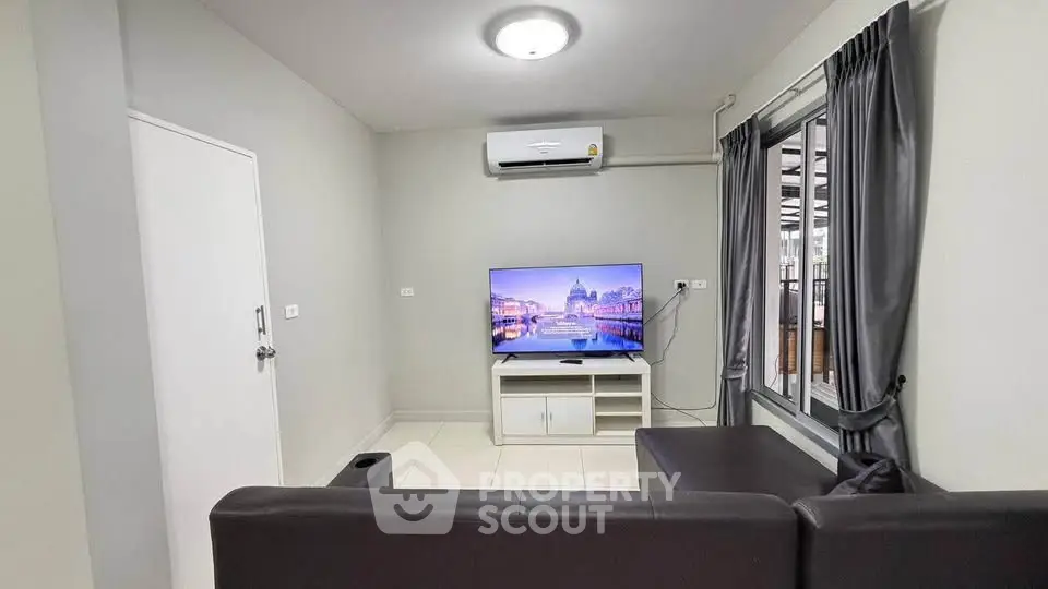 Modern living room with sleek furniture and large window for natural light