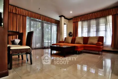 Spacious living room with elegant decor and large windows for natural light.