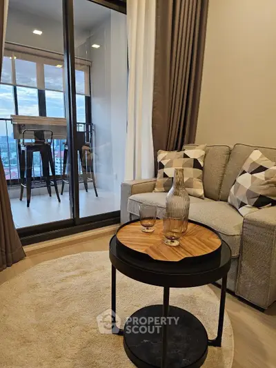 Stylish living room with cozy sofa and balcony view in modern apartment