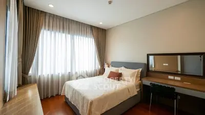 Cozy bedroom with elegant decor, featuring a comfortable bed and a stylish desk, perfect for relaxation and work.