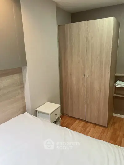 Cozy bedroom with wooden wardrobe and modern decor