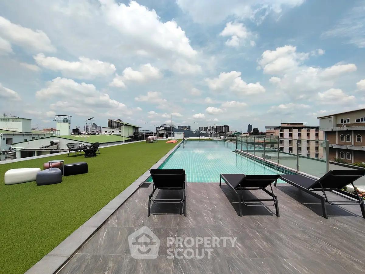 Luxurious rooftop pool with stunning city views and modern lounge chairs.