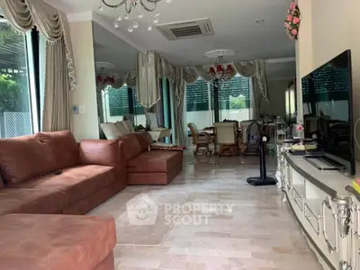 Spacious living room with elegant decor and large windows offering natural light.