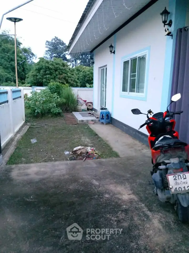 Charming single-story home with garden and motorbike parking in quiet neighborhood.