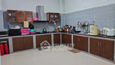 Spacious kitchen with modern appliances and ample storage in a stylish home.