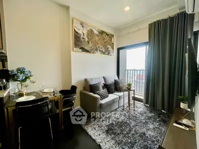 Modern living room with cozy sofa, stylish decor, and balcony access in a chic apartment.