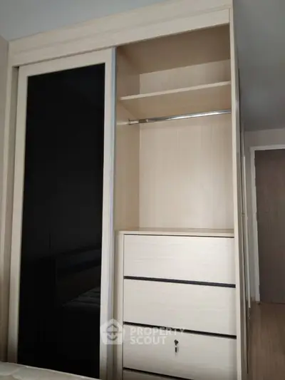 Modern built-in wardrobe with sliding doors and ample storage space