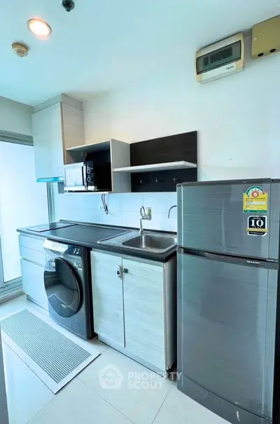 Modern kitchen with sleek appliances and ample storage space