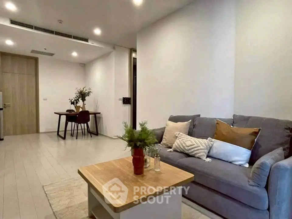 Modern living room with cozy sofa and stylish decor in open layout apartment.