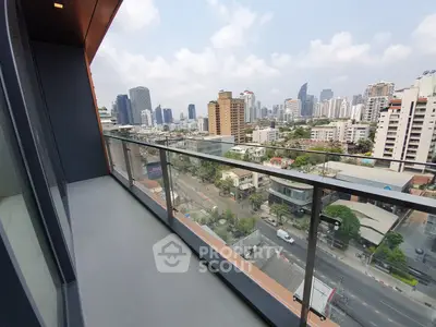Spacious balcony with stunning cityscape view in modern high-rise building.