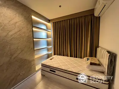 Cozy bedroom with modern lighting, elegant drapery, and a comfortable single bed, perfect for restful nights in a stylish urban apartment.