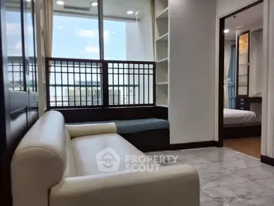 Modern living room with white sofa and large window offering city view