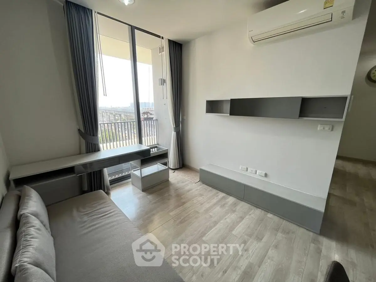 Modern living room with sleek furniture and balcony view