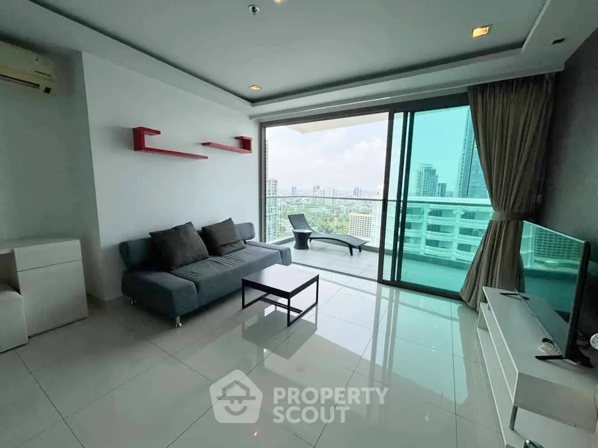 Modern living room with city view and large balcony in high-rise apartment