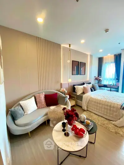 Stylish modern bedroom with cozy seating area and elegant decor