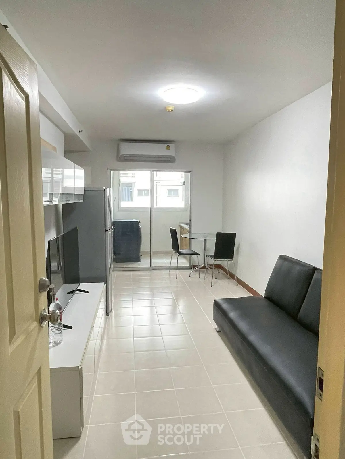 Modern apartment living room with sleek furniture and natural light