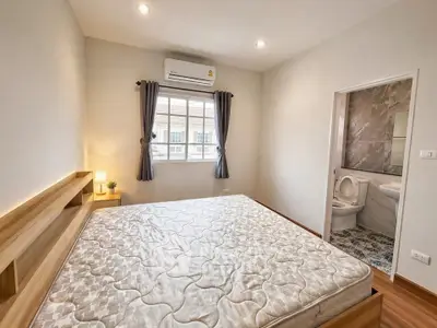 Spacious bedroom with ensuite bathroom and large window for natural light.