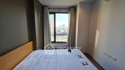 Modern bedroom with city view, large window, and minimalist design