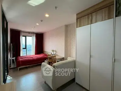 Cozy bedroom with city view, featuring modern furniture and ample natural light.