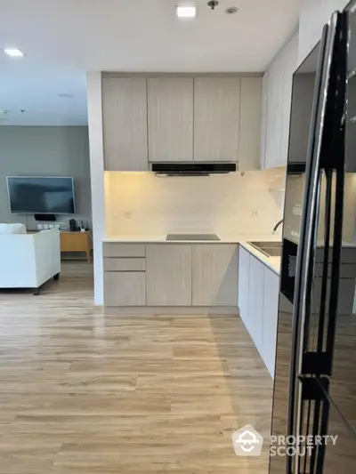 Modern kitchen with sleek cabinetry and open layout in stylish apartment