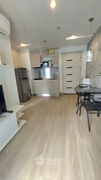 Modern open-layout kitchen and dining area with sleek appliances and stylish decor.