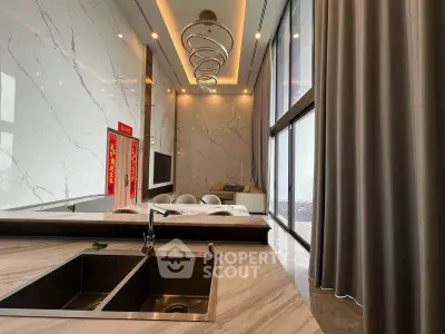 Luxurious modern living room with high ceilings and elegant marble finishes.