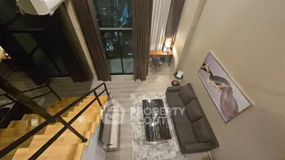Luxurious modern living room with high ceilings and elegant decor in a stylish apartment.