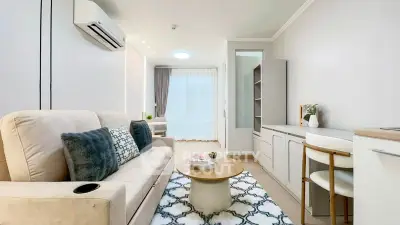 Modern living room with cozy sofa, stylish decor, and natural light in a contemporary apartment.