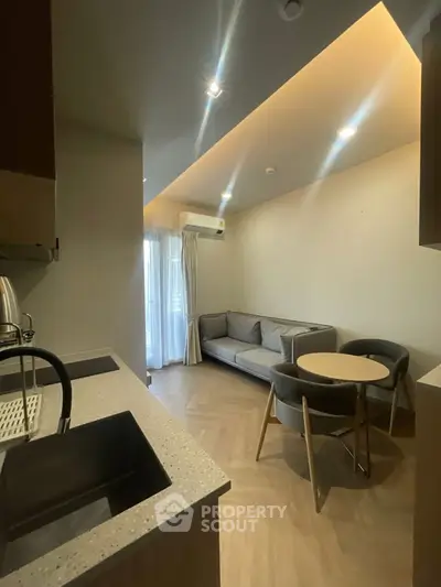 Modern living room with cozy seating and stylish kitchen area