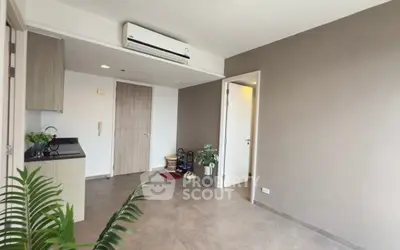 Modern apartment interior with air conditioning and sleek kitchen area.