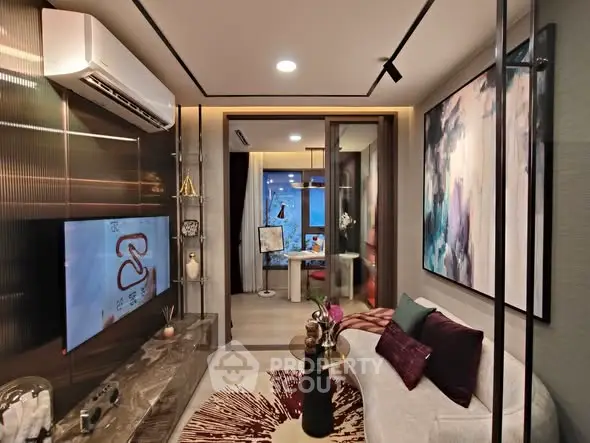 Modern living room with stylish decor and open layout leading to a cozy study area.